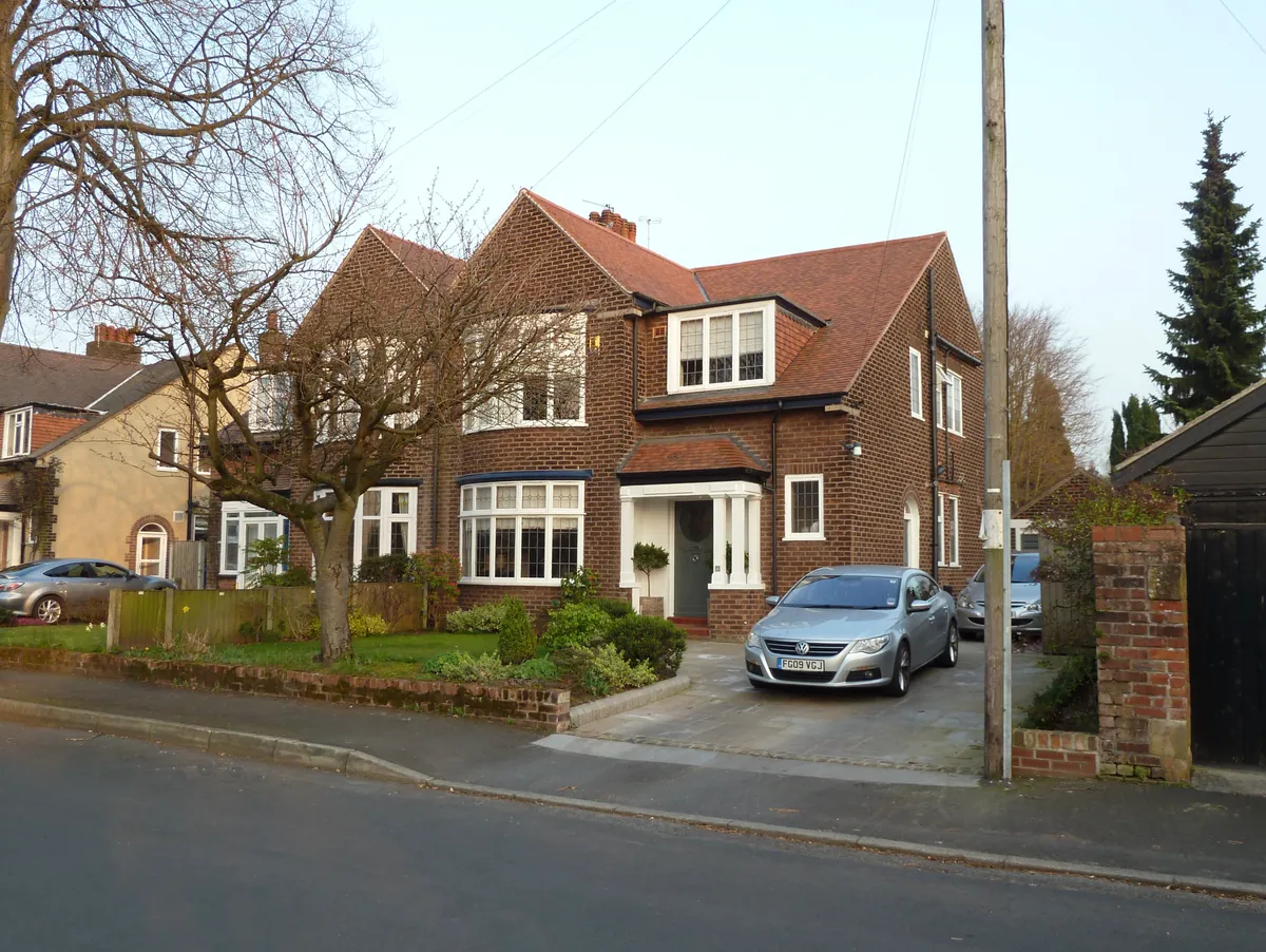 Red-brick semi-detached houses with bay windows on Grange Avenue, Hale