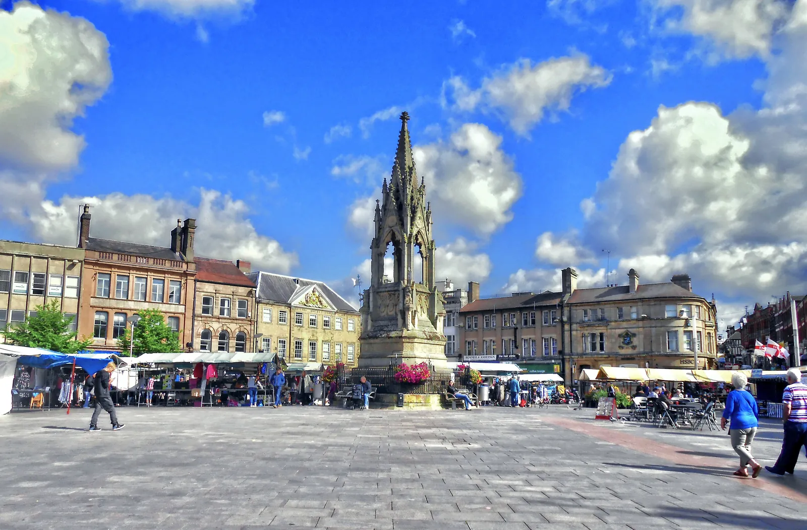 The Bentinck Memorial in Mansfield Market Place, with market stalls and old shopfronts around it
