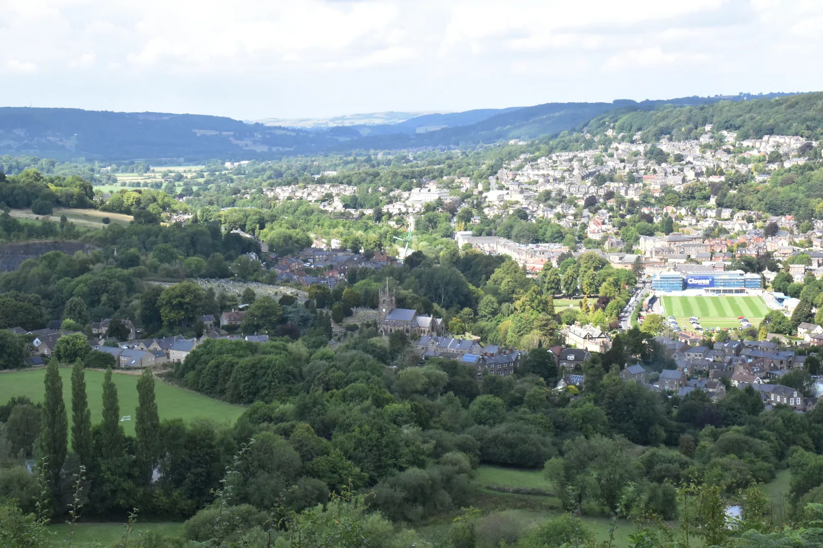 Matlock spread across the green Derwent Valley, seen from the hillside below Riber