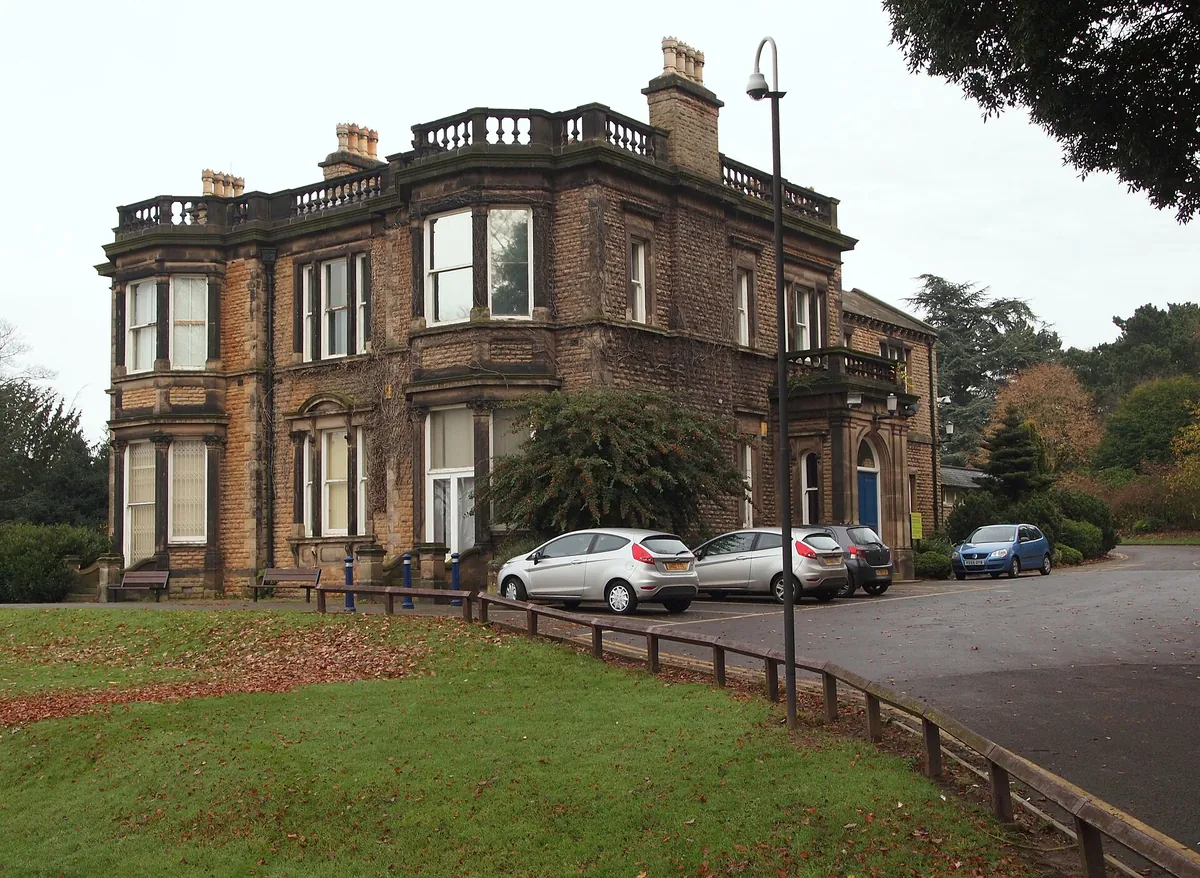 A large Victorian stone villa with bay windows and a balustraded roof in Sherwood, Nottingham