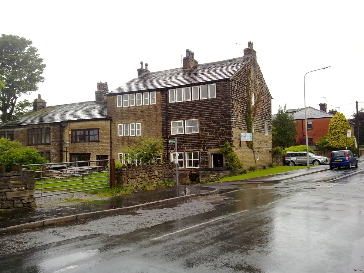 Stone weavers' cottages with rows of upstairs windows in Wardle